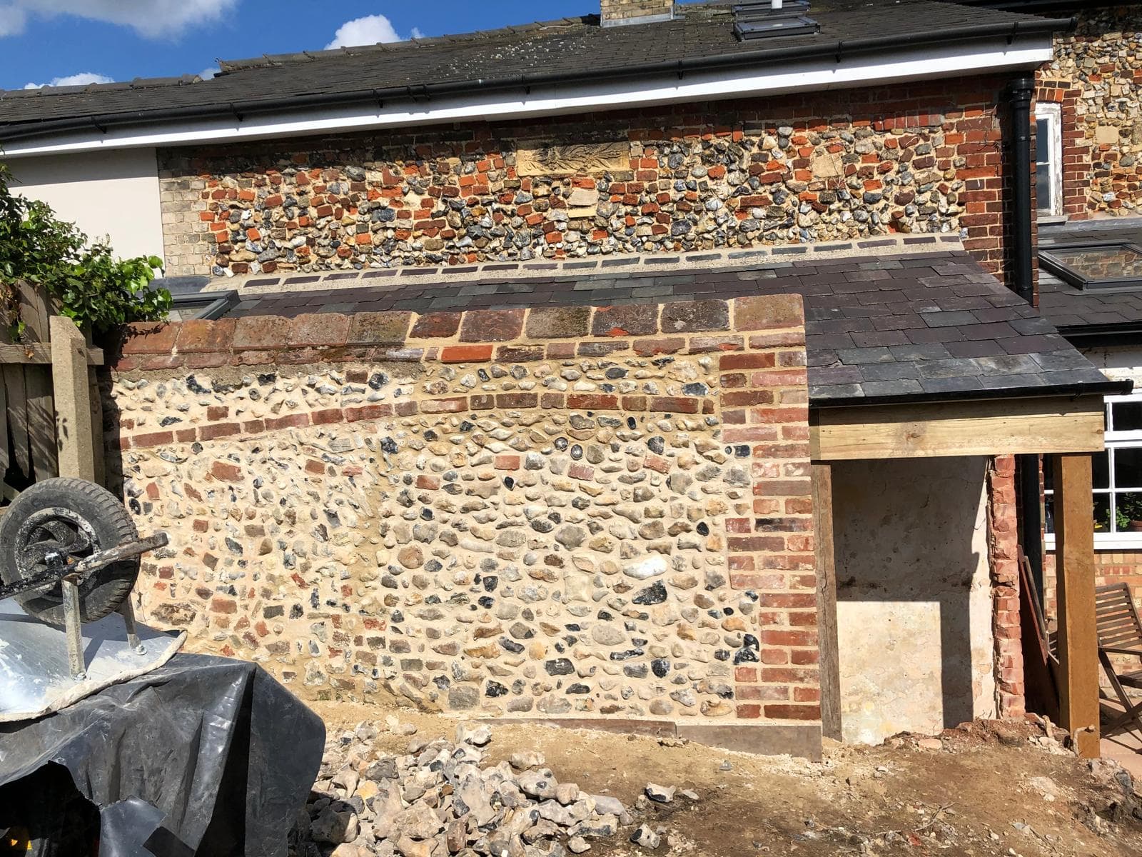 Flintwork wall with brick piers and copings